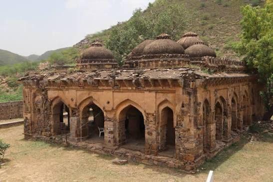 Dehra Mandir, an ancient temple in Nuh, Haryana, with traditional red sandstone and masonry work undergoing rejuvenation