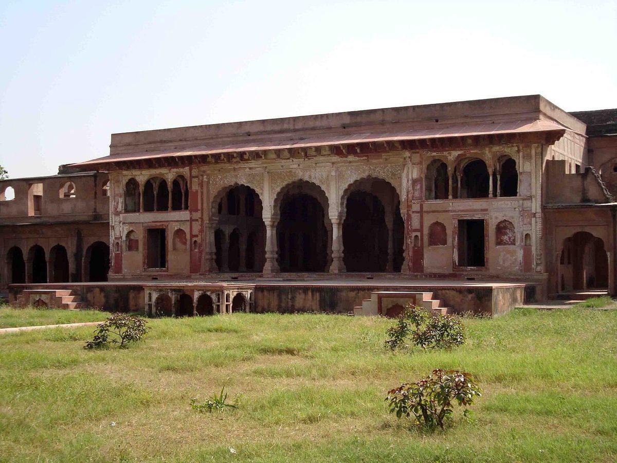 Sheesh Mahal, a heritage palace in Gurugram, Haryana, with weathered arched openings, decorative stonework, and traditional facade undergoing rejuvenation